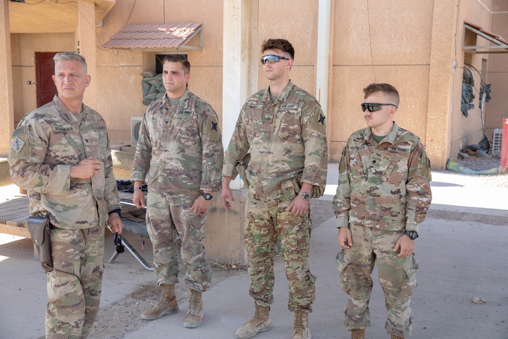 Col. Desormeaux presents coins to troops