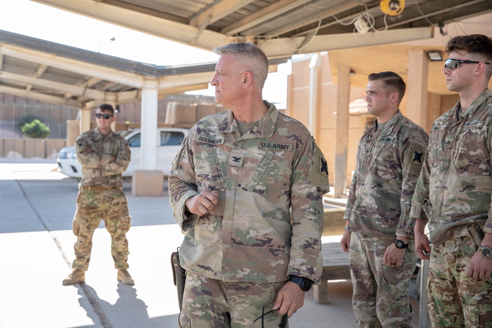 Col. Desormeaux presents coins to troops