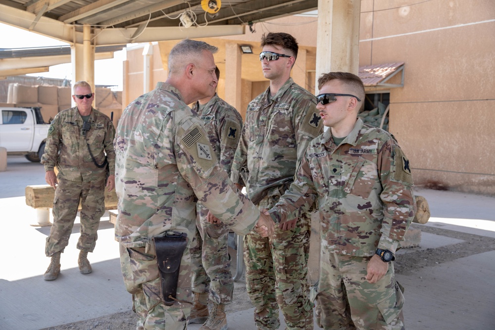 Col. Desormeaux presents coins to troops