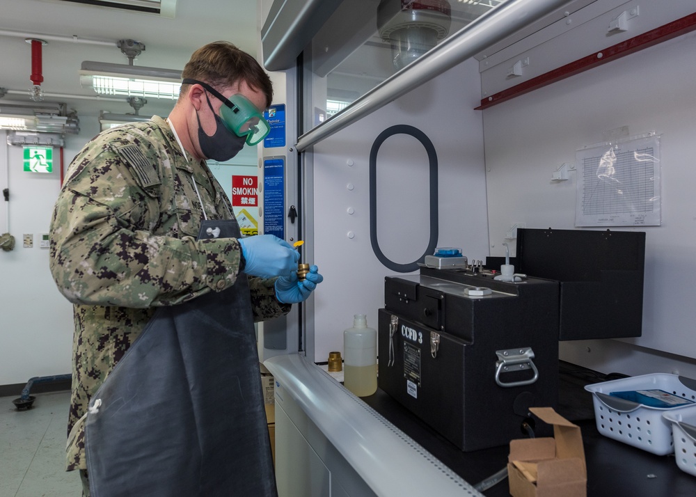 Aviation Boatswain’s Mate (Fuels) Tests Fuel Sample