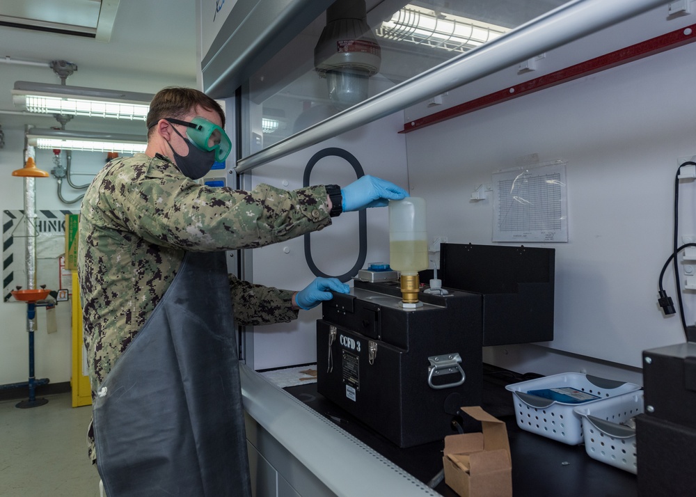 Aviation Boatswain’s Mate (Fuels) Tests Fuel Sample