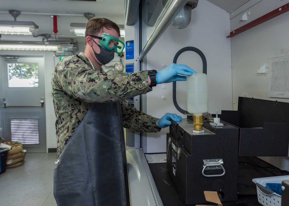 Aviation Boatswain’s Mate (Fuels) Tests Fuel Sample