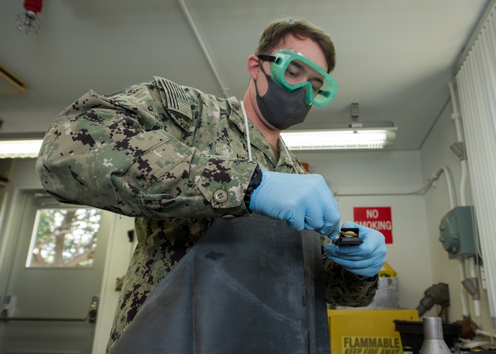 Aviation Boatswain’s Mate (Fuels) Tests Fuel Sample