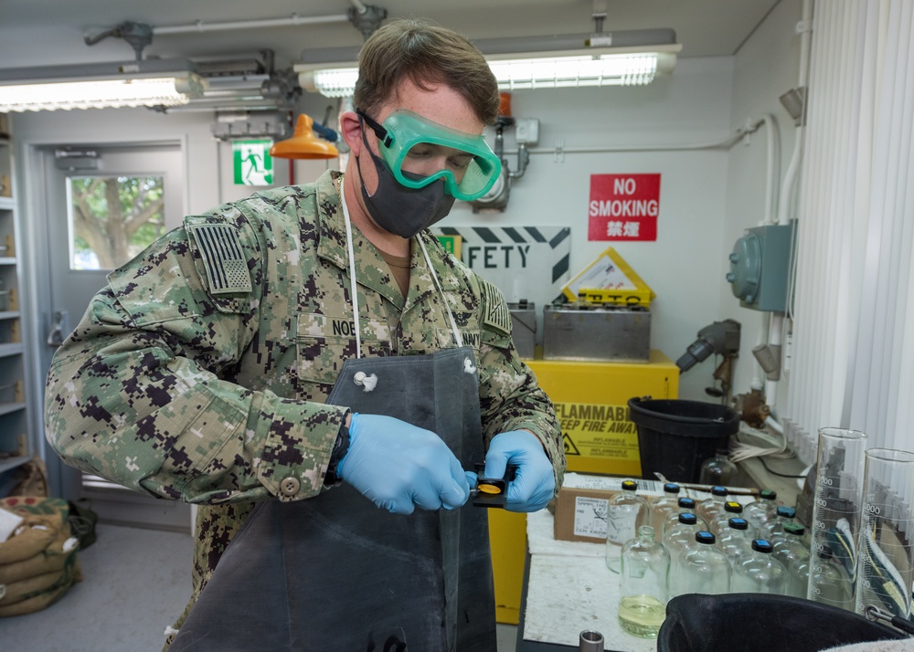 Aviation Boatswain’s Mate (Fuels) Tests Fuel Sample