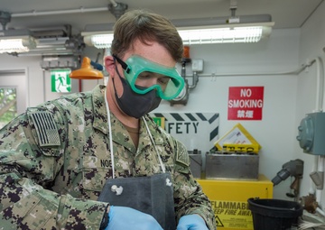 Aviation Boatswain’s Mate (Fuels) Tests Fuel Sample