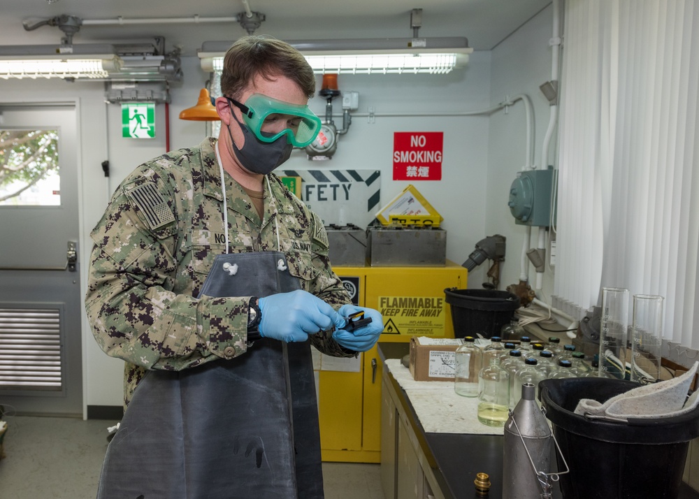 Aviation Boatswain’s Mate (Fuels) Tests Fuel Sample