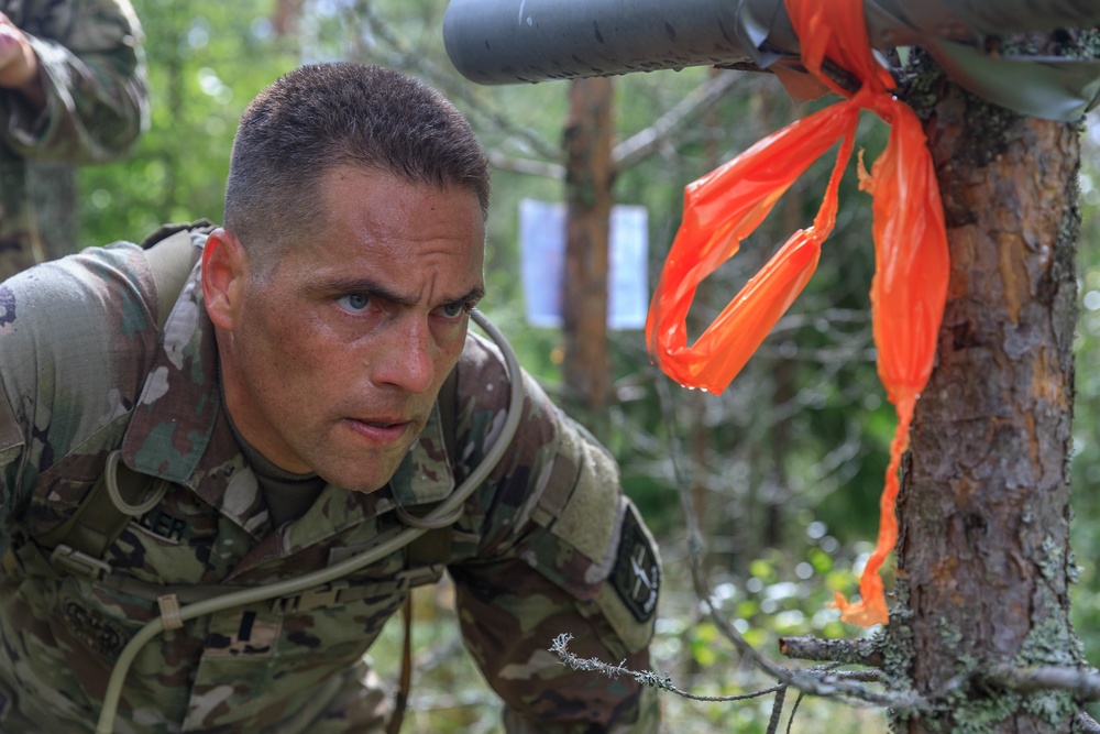 1st Lt. Joshua Moeller looks at a target in order to estimate distance