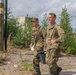 Maj. James Fink and Sgt. Michael Yarrington carry a weight to the finish