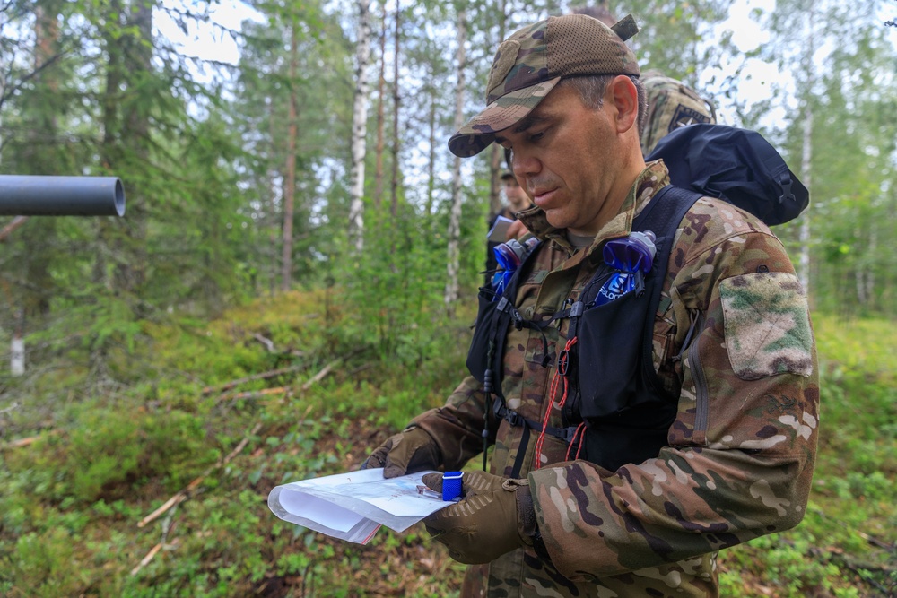 Col. Ryan “MZ” Montanez looks at the map to determine his team's next point