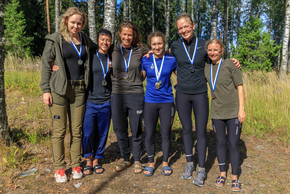 Female competitors pose with their medals