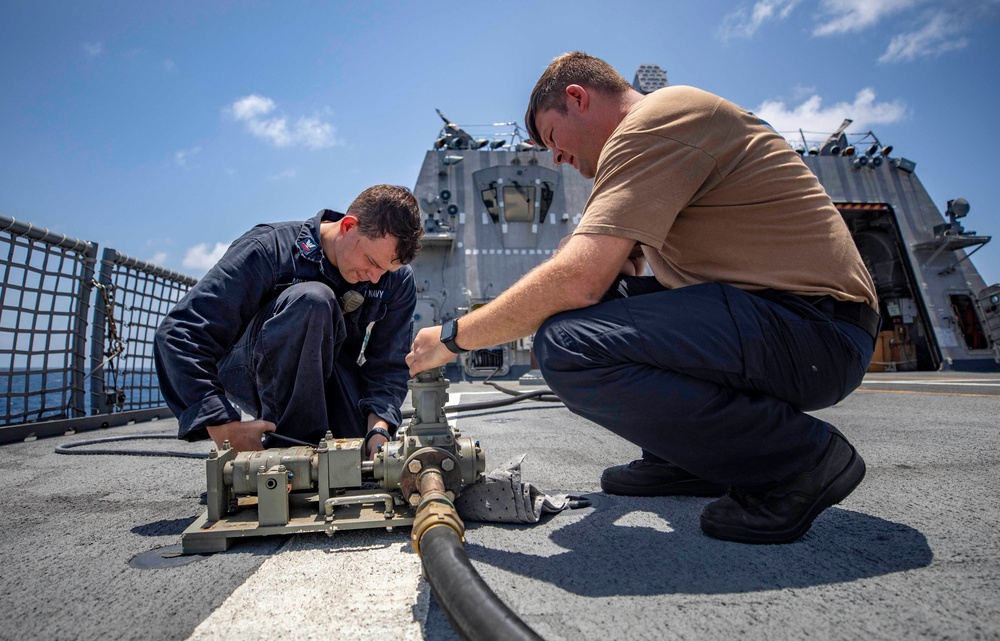 USS Billings and HSC 28 Sailors Operate a Pneumatic Pump