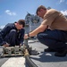 USS Billings and HSC 28 Sailors Operate a Pneumatic Pump