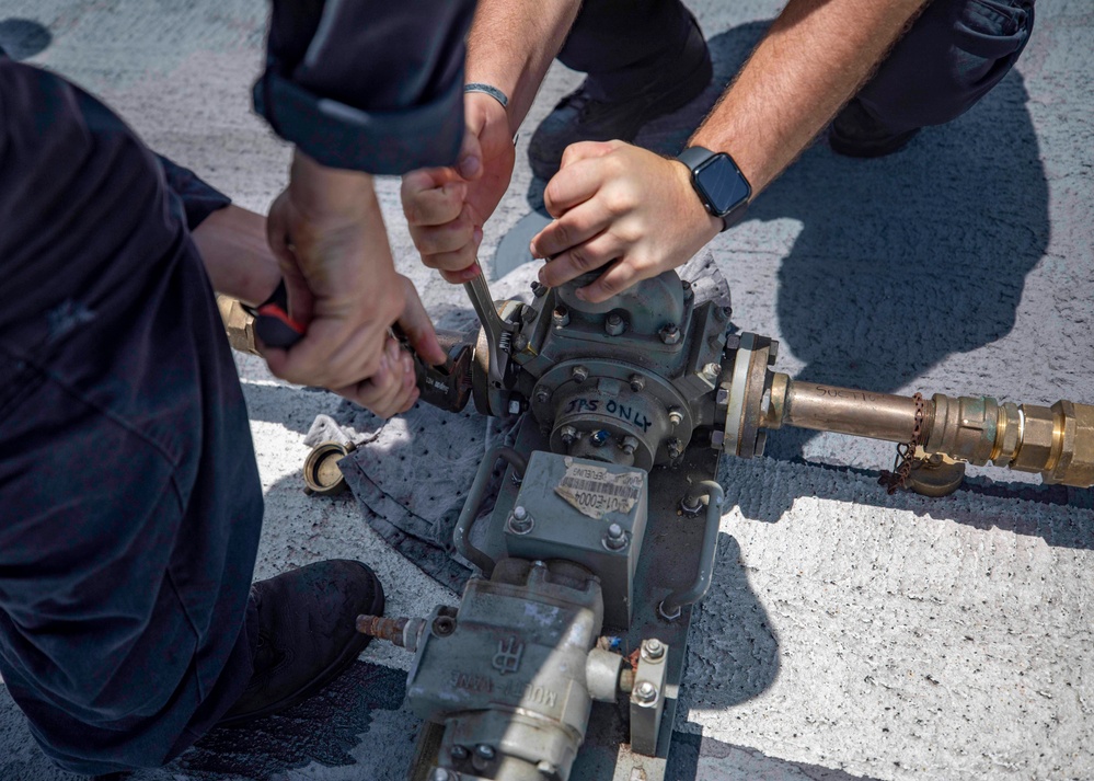 USS Billings and HSC 28 Sailors Operate a Pneumatic Pump