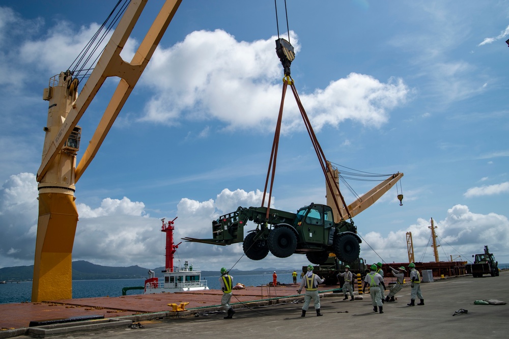 U.S. Army 835th Transportation Battalion and U.S. Navy Seabees with NMCB-5 transport civil engineer support equipment to Papau New Guinea