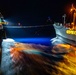 Arlington conducts a night time underway replenishment