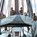 Sailors furl the mizzen topsail aboard USS Constitution