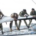 Sailors furl the mizzen topsail aboard USS Constitution