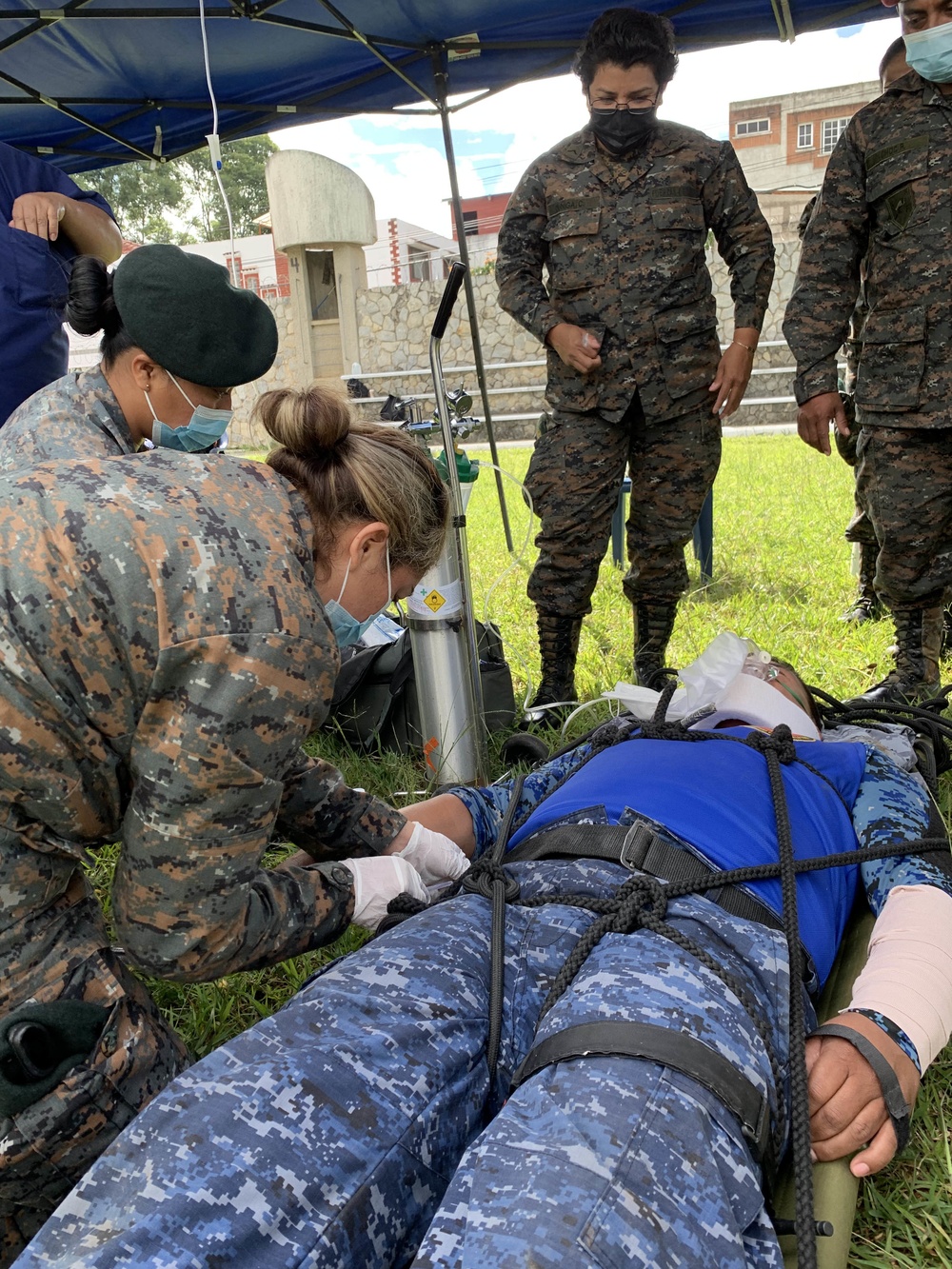 Guatemalan Military Nurses Prepare a Simulated Patient for Transport During Southern Partnership Station 2021