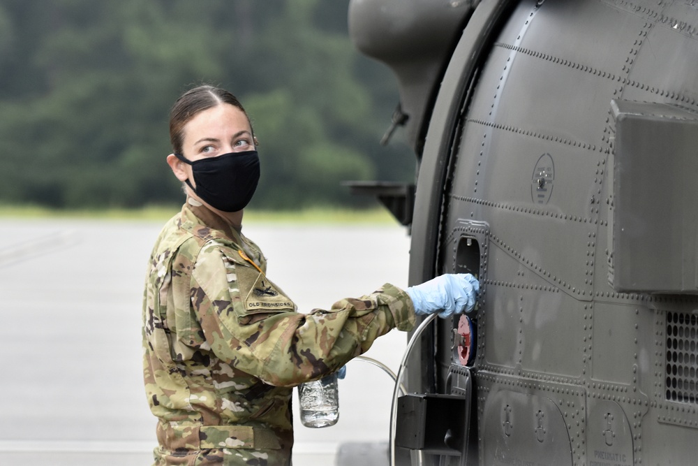 Soldier taking fuel sample on Black Hawk