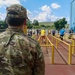 Col. Ryan “MZ” Montanez watches as Romanian Reserve service members run through an obstacle
