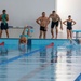American reserve service members train Romanian Reserve service members on the water obstacle course
