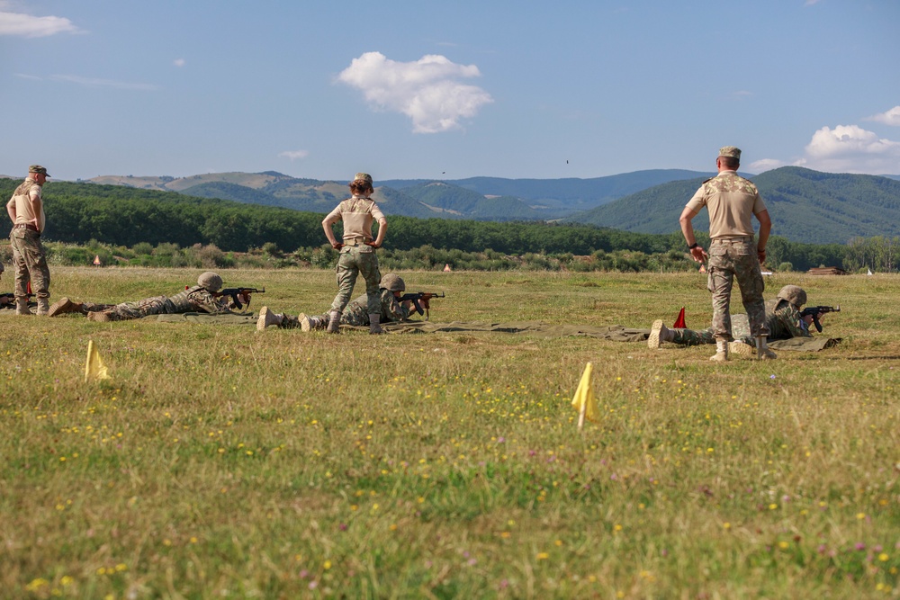 Army Reserve and Romanian Reserve service members fire an AK-47 rifle