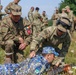 Sgt. Morgan Figgs teaches a Romanian Reserve Soldier rifle marksmanship techniques