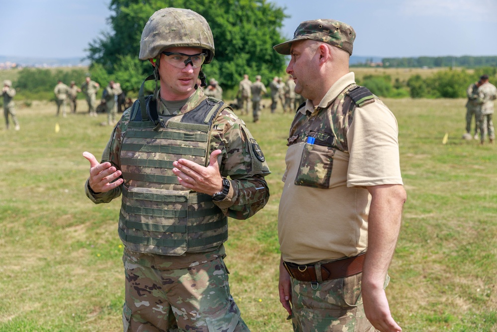 Sgt. Michael Yarrington talks with a Romanian range safety officer