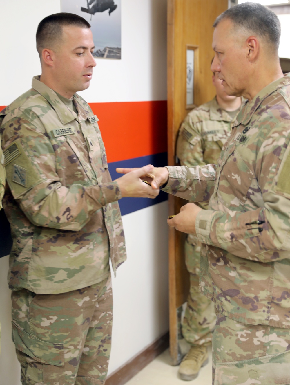 Brig. Gen. Michael Adame and Brig. Gen. Joseph Reale coin Soldiers at Camp Buehring