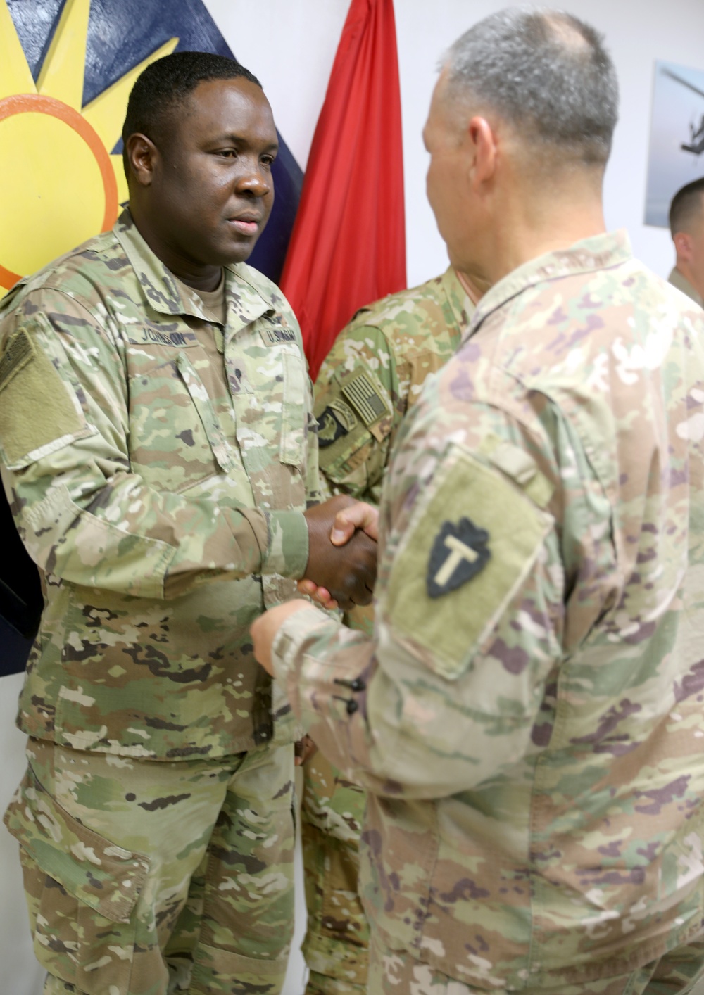 Brig. Gen. Michael Adame and Brig. Gen. Joseph Reale coin Soldiers at Camp Buehring