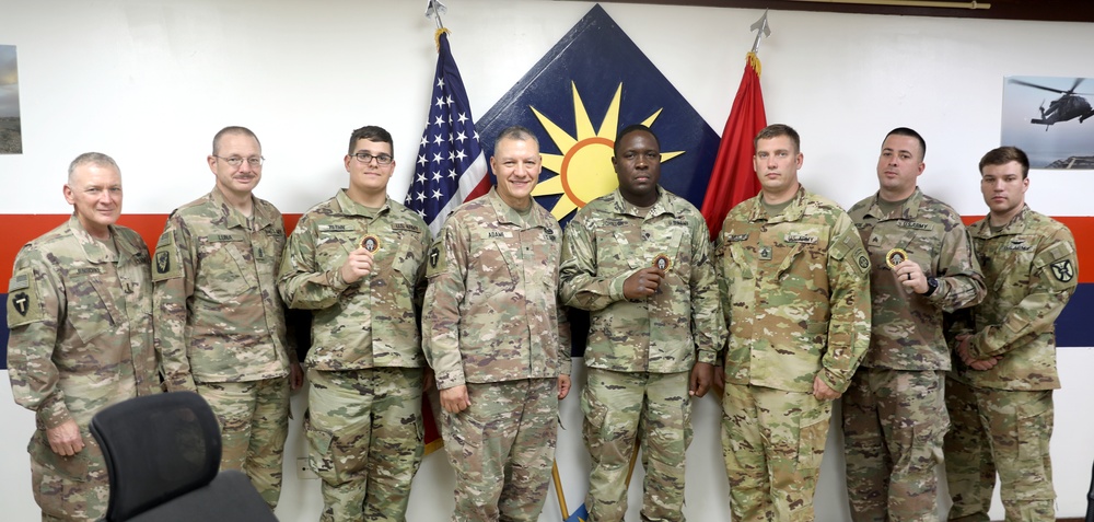 Brig. Gen. Michael Adame and Brig. Gen. Joseph Reale coin Soldiers at Camp Buehring