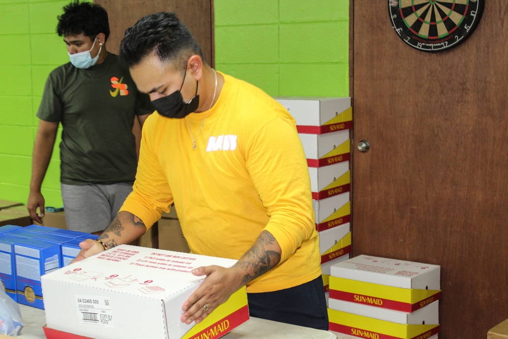 Guam Sailors and Deployed Marines Package Food for Families in Need