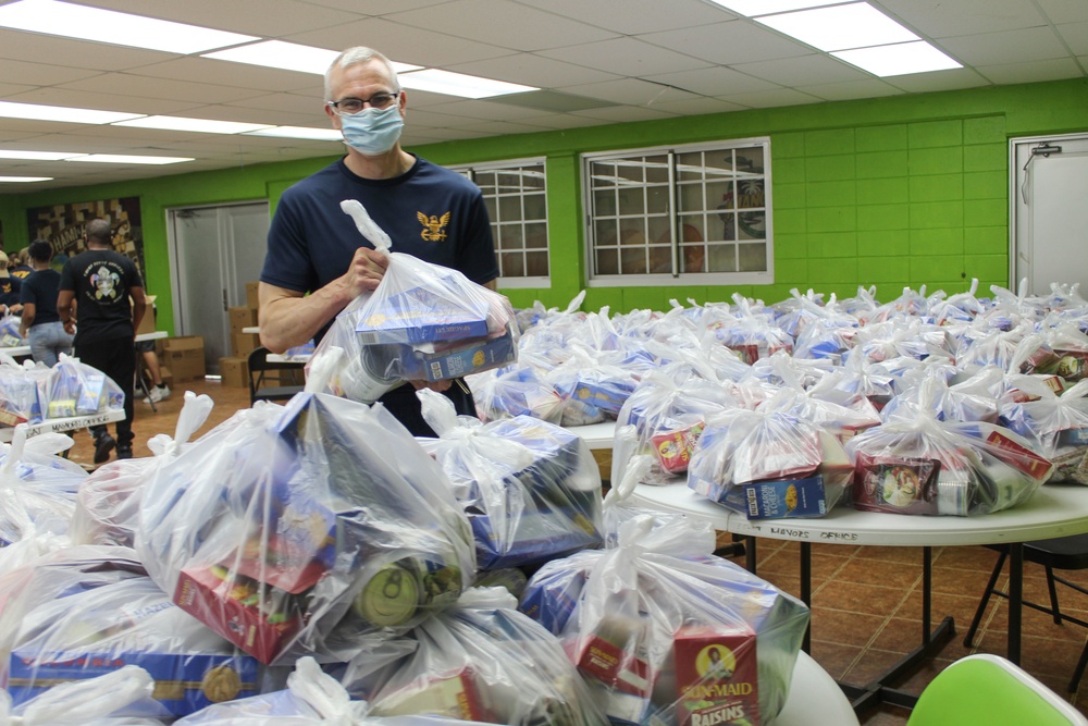 Guam Sailors and Deployed Marines Package Food for Families in Need