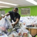 Guam Sailors and Deployed Marines Package Food for Families in Need