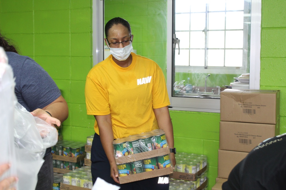 Guam Sailors and Deployed Marines Package Food for Families in Need