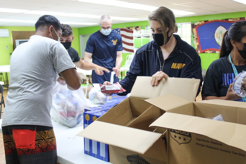 Guam Sailors and Deployed Marines Package Food for Families in Need