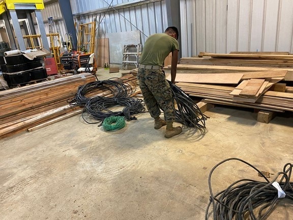 Marines untangle and sort electrical wires