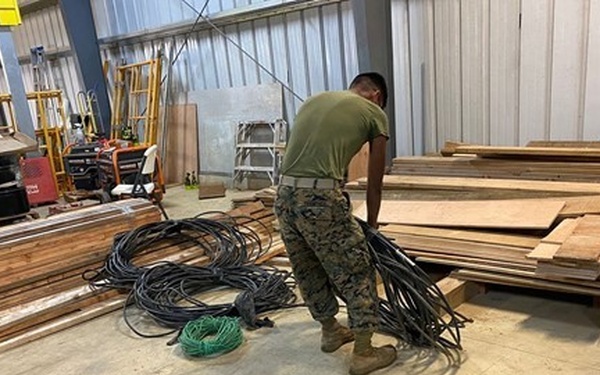 Marines untangle and sort electrical wires