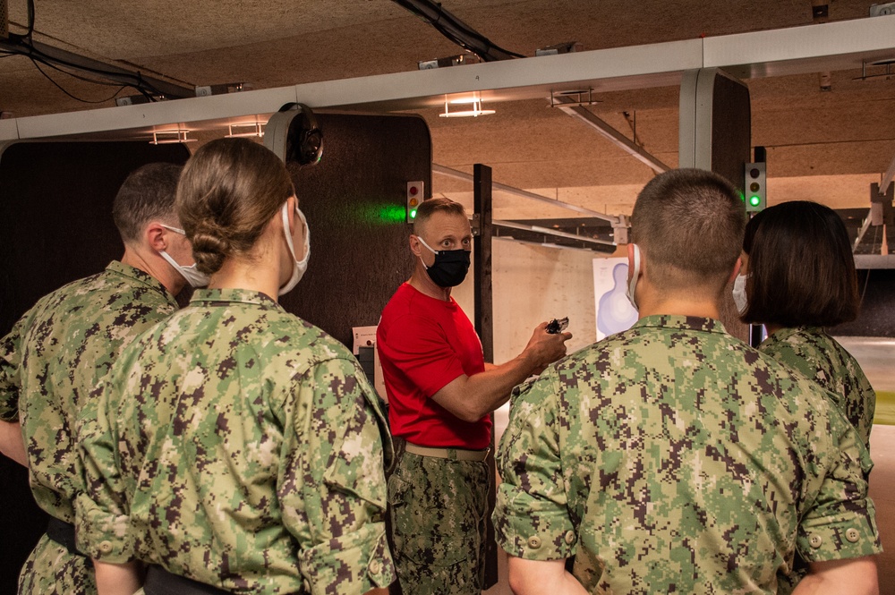 210803-N-YF306-0114 NEWPORT, R.I. (August 4, 2021)  Recruit Division Commander Instructs Officer Candidates During Small Arms Qualification