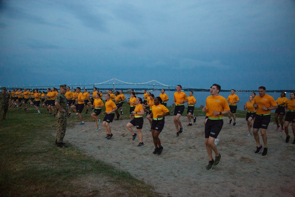 210804-N-YF306-0091 NEWPORT, R.I. (August 4, 2021)  Recruit Division Commander directs officer candidates during physical fitness