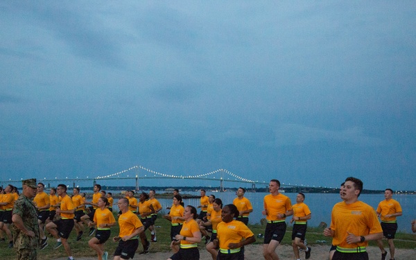 210804-N-YF306-0091 NEWPORT, R.I. (August 4, 2021)  Recruit Division Commander directs officer candidates during physical fitness