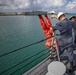 USS Billings Sailors Throw Training dummy Over the Side of the Ship During Search and Rescue Training