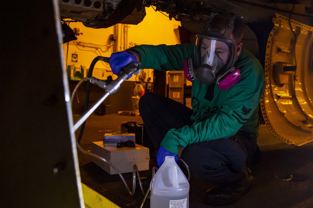 Sailors perform preventative maintenance on F/A-18E Super Hornet