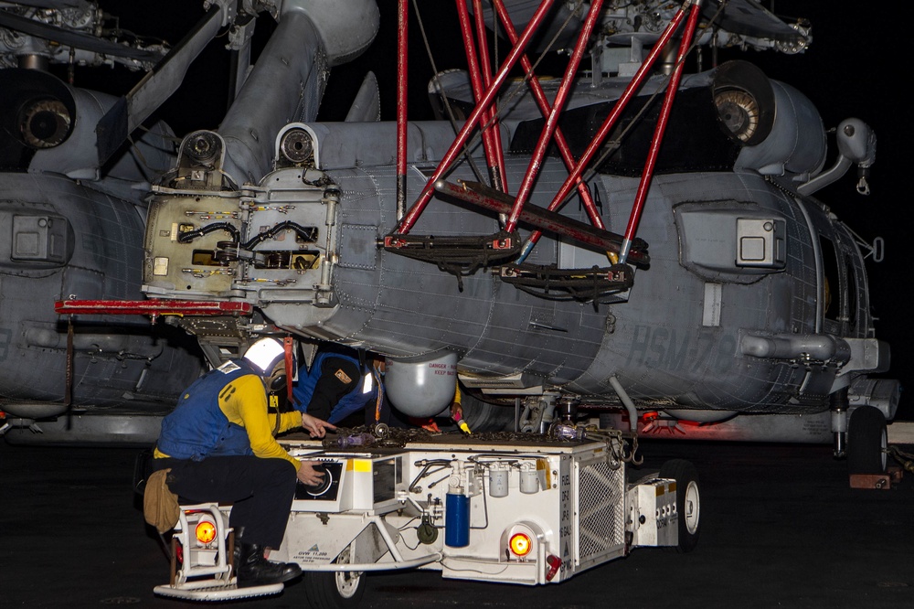 A Sailor transports an MH-60R Sea Hawk