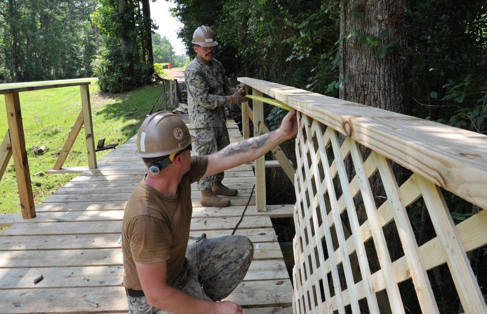 Seabees from NMCB 133 repair walking bridge.