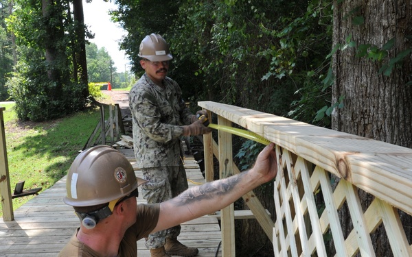 Seabees from NMCB 133 repair walking bridge.