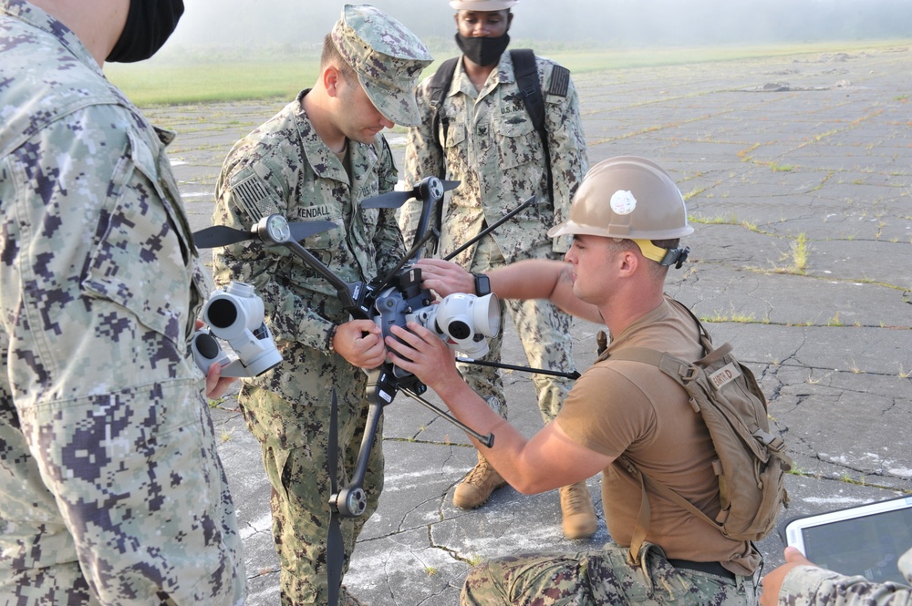 Seabees from NMCB 133 survey damage to begin their airfield damage repair evolution during LSE 2021