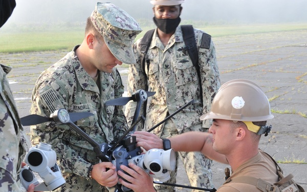 Seabees from NMCB 133 survey damage to begin their airfield damage repair evolution during LSE 2021