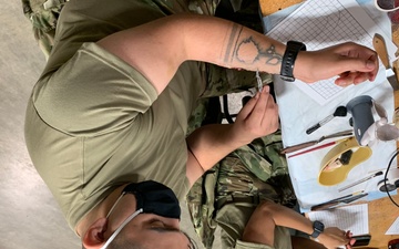 Soldiers from Medical Readiness Training Command's effects and enabler's team apply combat moulage during Global Medic at Fort McCoy, Wisconsin