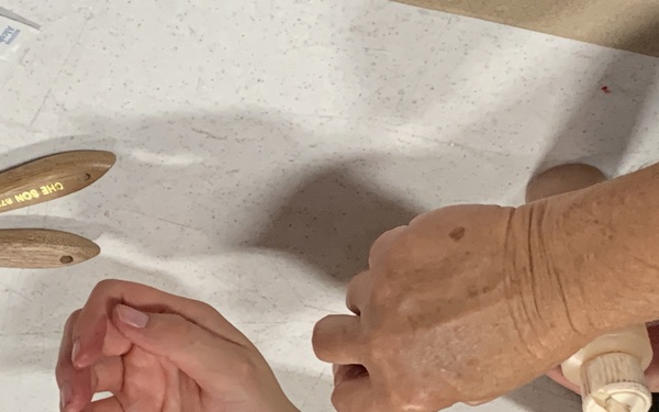 A combat moulage instructor demonstrates how to create realistic simulated combat wounds